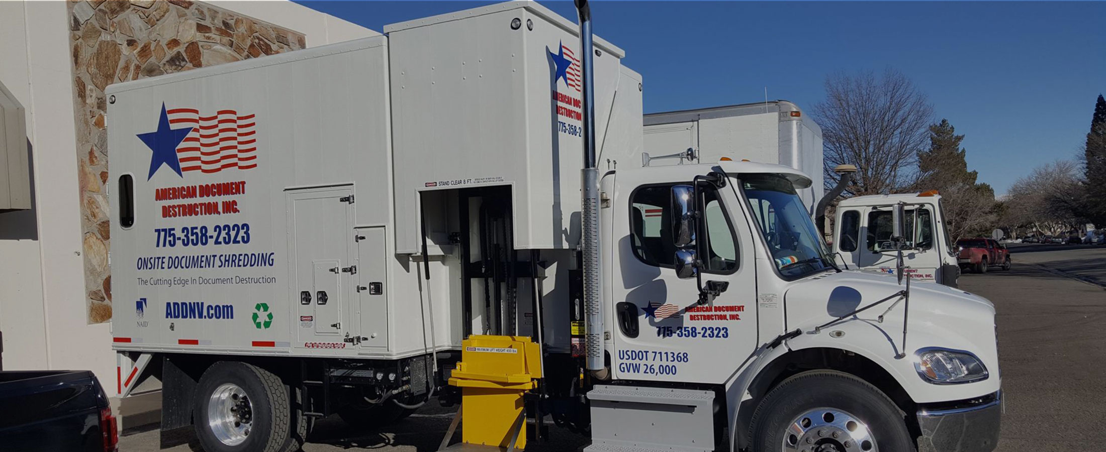 Multiple American Document Destruction trucks parked